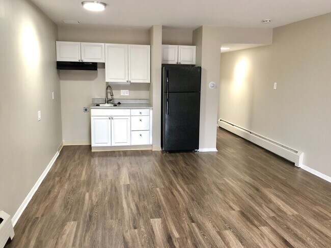 Experience modern culinary design in this chic apartment kitchen. - GRACE LANDINGS APARTMENTS