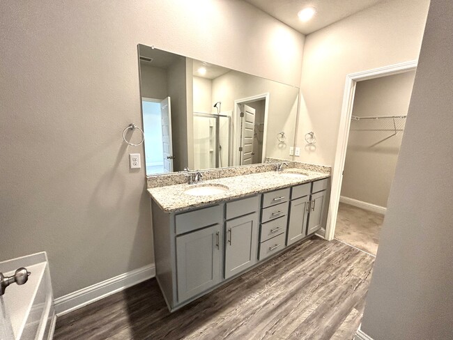 Master bath offers double bowl vanity, large walk-in closet and separate soaking tub and toilet - 31524 Plover Ct