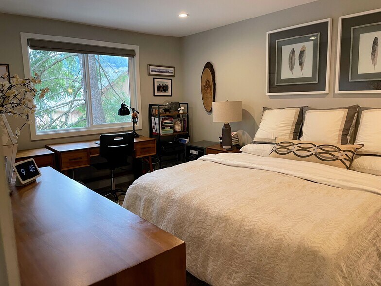 Primary treehouse bedroom with king bed, 2 nights, dresser and office - 280 NW Holly St