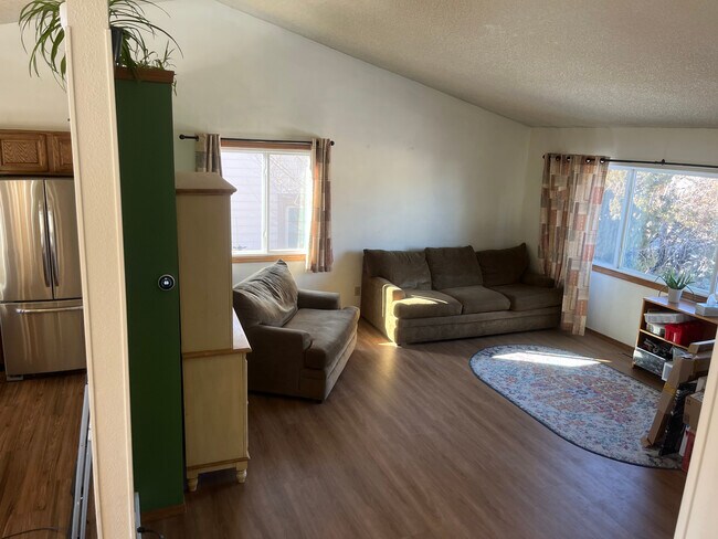 View from stairs: front room on right, 3/4 wall, and kitchen on left - 2619 15th Ave