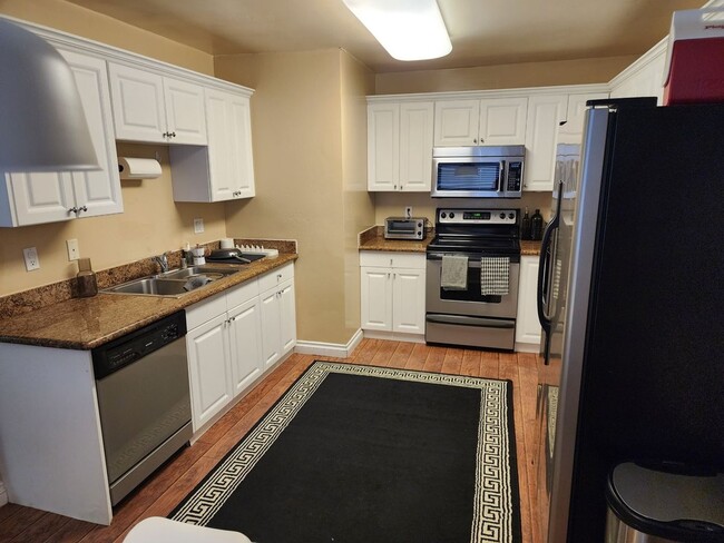 Building Photo - 2 bedroom condo- top floor- with  detached garage