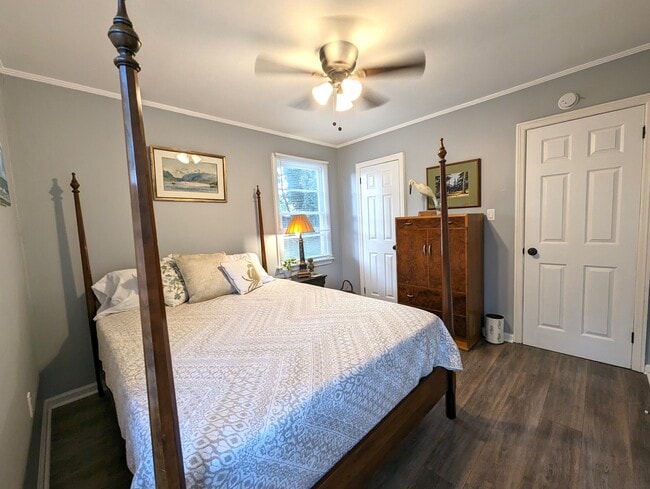 Bedroom 1 is bright and inviting. Queen bed, original art and a closet. - 4107 Crane St
