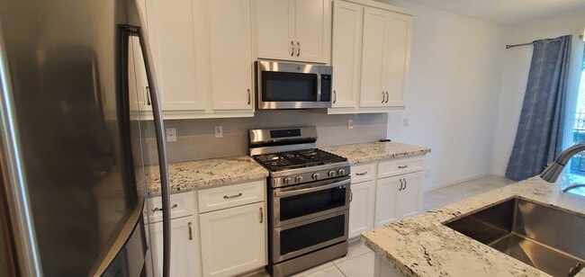 Building Photo - Beautiful townhome features a bright, open-concept layout