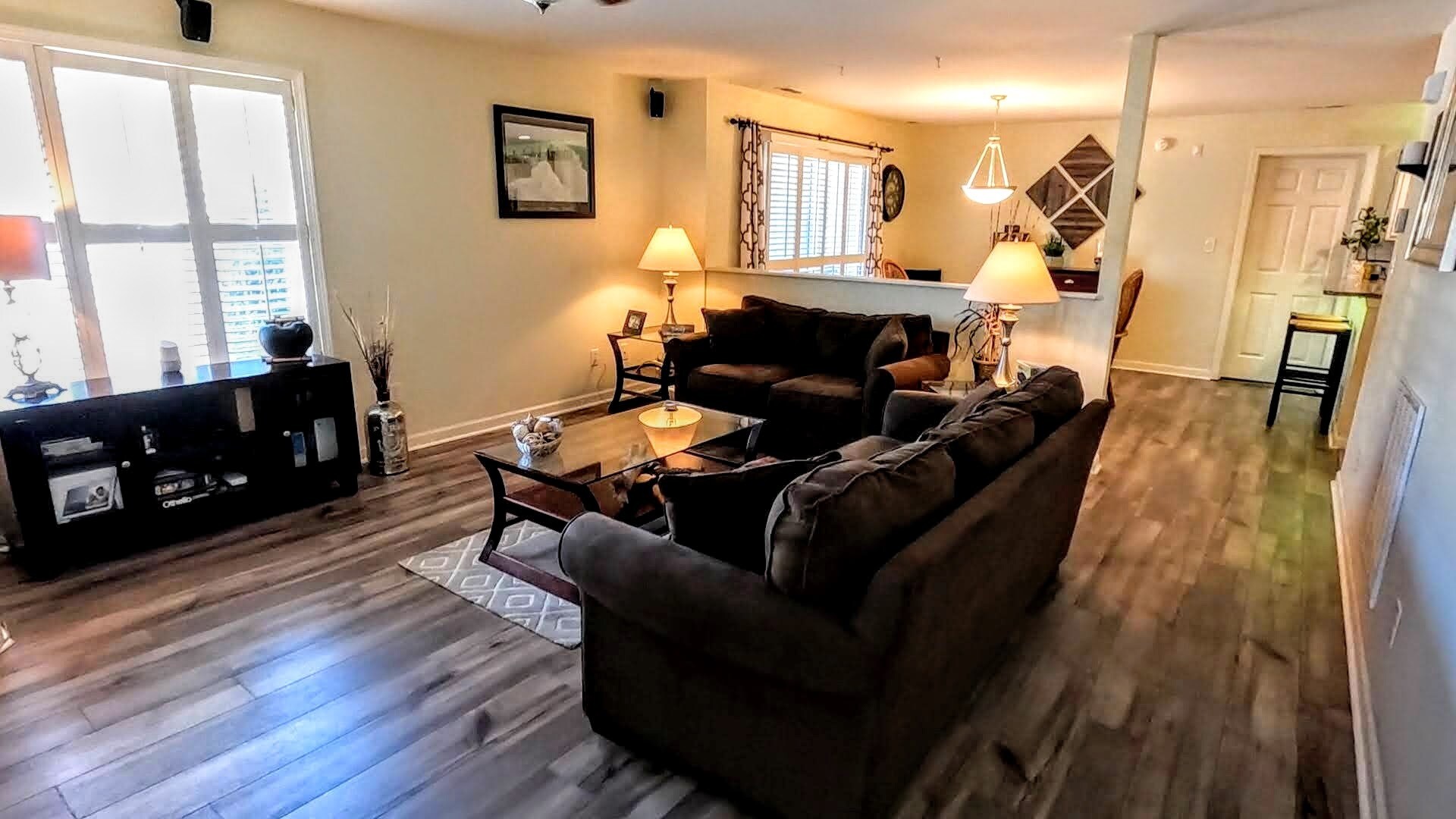 View of the main living area, with the dining area beyond. Guest bed and bath located to your right. - 424 Commerce Ave