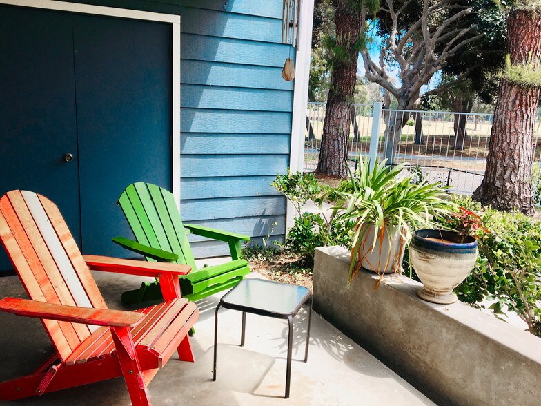 Two colorful patio chairs to relax w/ coffee - 6000 Bixby Village Dr