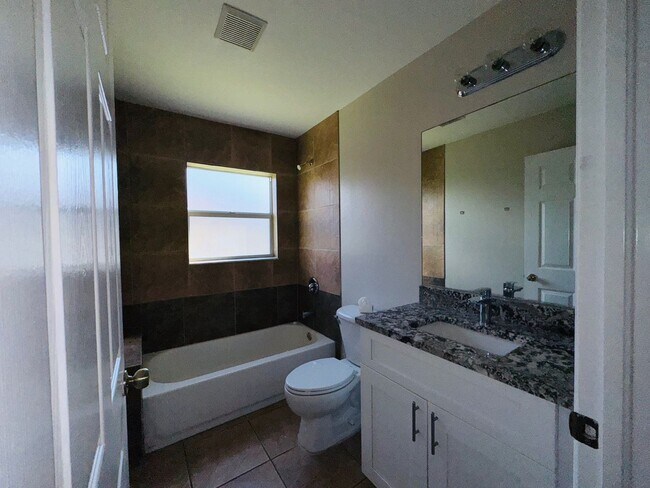 Building Photo - Experience this Cape Coral 3 bedroom 2 bath corner duplex with 1 car garage and screened in lanai.