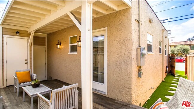 deck. door on left is washer/dryer, middle door is garage, right door goes into kitchen - 319 W Chevy Chase Dr