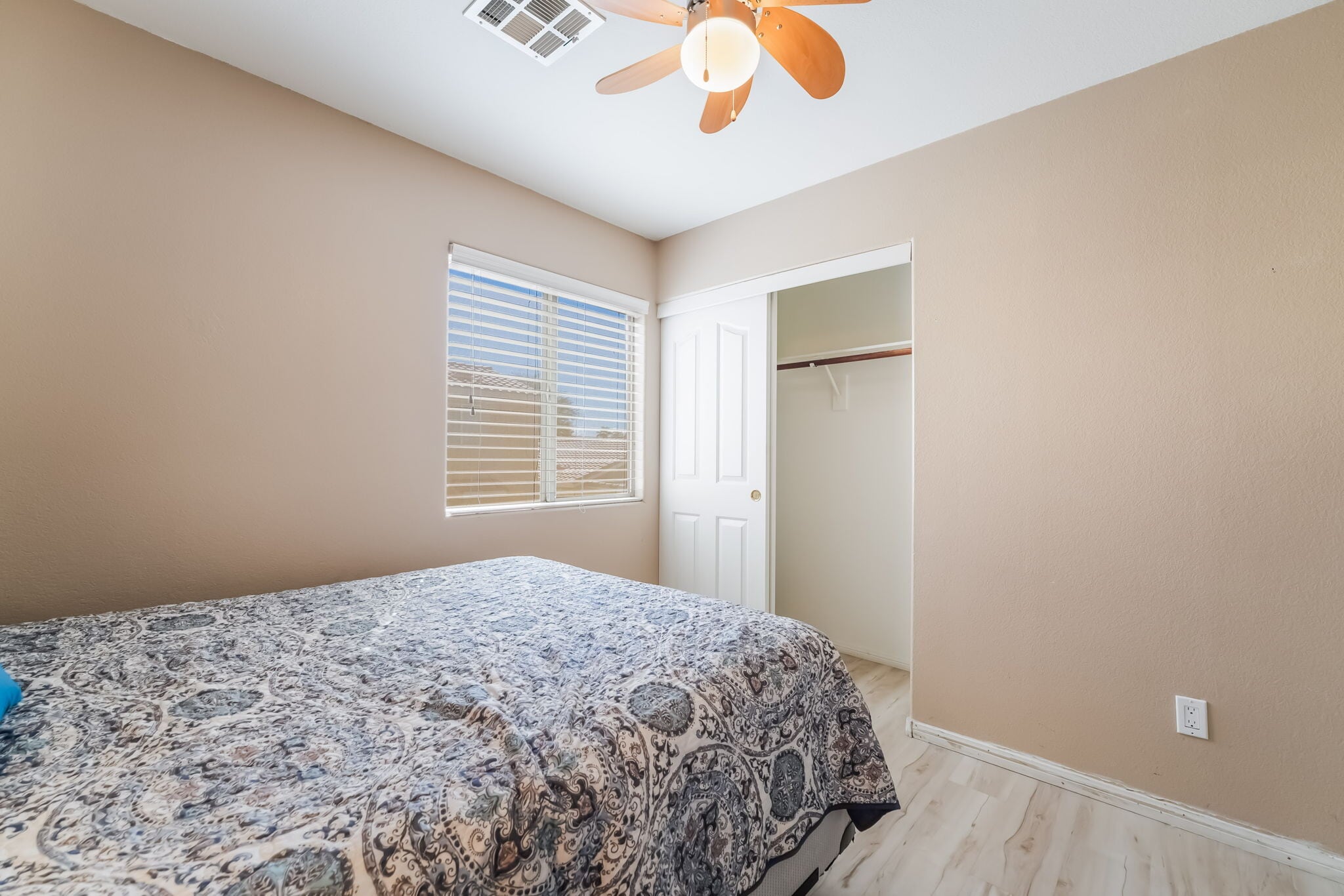 Bedroom with light wood-style floors, a closet, and ceiling fan - 1179 Antoinette St