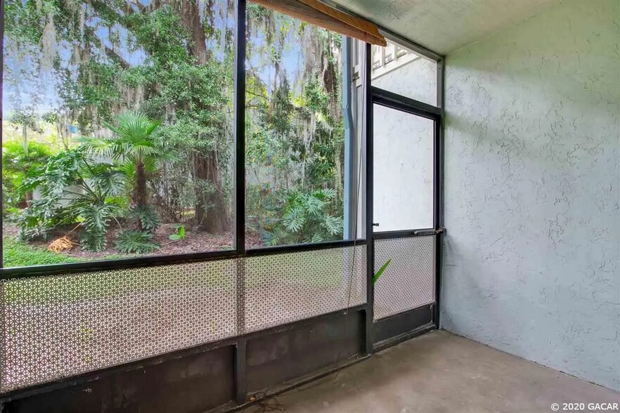 Screened-in patio with view to nature. - 4411 SW 34th St
