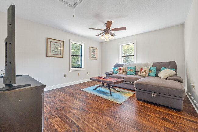 Open living room with comfy seating and a Smart TV - 1090 Quail Trl