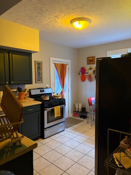 Kitchen with stainless appliances, refinished cabinets, and gas oven. - 2580 Deming Ave