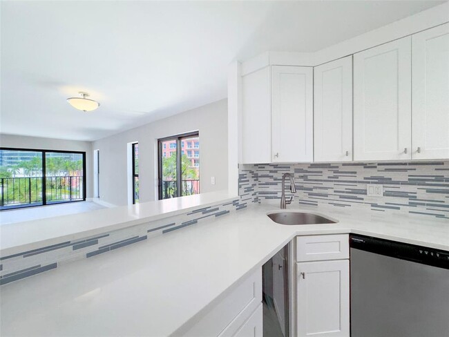 5 / 27Cook and entertain in the updated kitchen with view out through multiple windows. - 2029 N Ocean Blvd