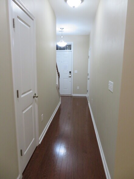 Looking from Great Room to front door.Door on right to the garage. Door left is understairs storage - 2496 Stadium Dr