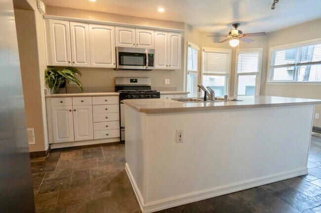 island and a wall of cabinet space behind it - 2406 P St