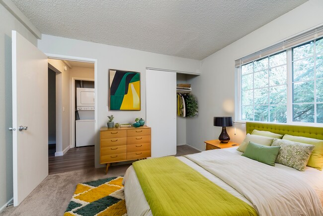 Experience tranquility in this charming bedroom with warm decor and abundant natural light. - University Crossing Apartments
