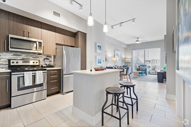 Kitchen and kitchen island within open concept apartment in Boca Raton. - Boca City Walk