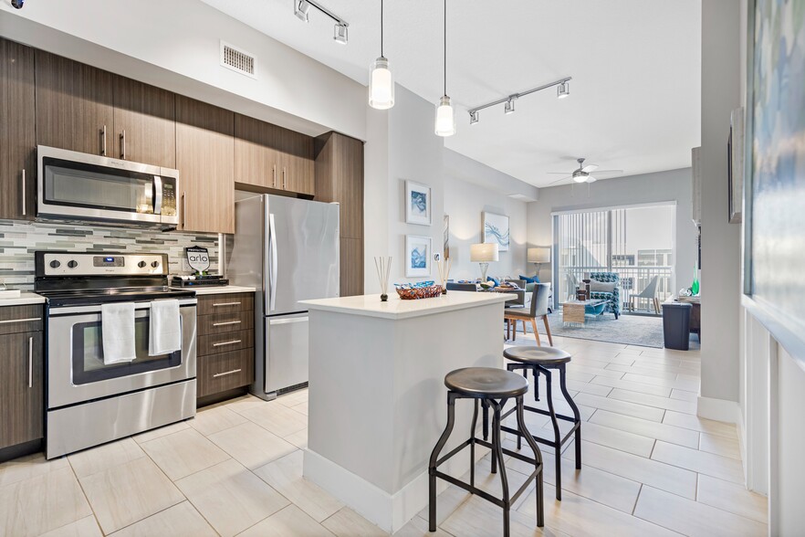 Kitchen and kitchen island within open concept apartment in Boca Raton. - Boca City Walk