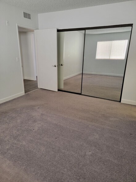 Primary bedroom with view toward hallway - 3751 S Canfield Ave