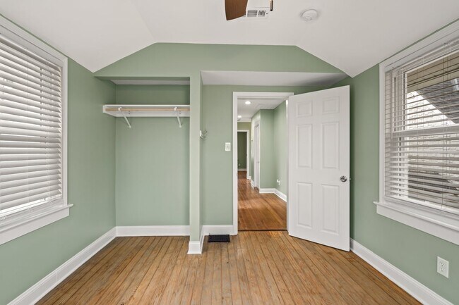 Bedroom #3 upstairs with vaulted ceilings, plenty of natural light and view of spacious backyard - 4517 Tracy Ave