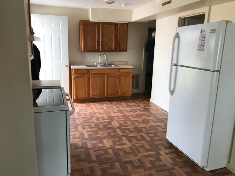 Front entrance to kitchen, complete with Refrigerator and electric stove. - 18 Hewett St