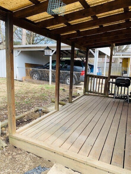 covered rear deck, fenced back yard, carport with attached storage shed - 211 E Vermilya Ave