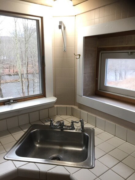 Kitchen sink view of the river and the yard - 6201 NY-42