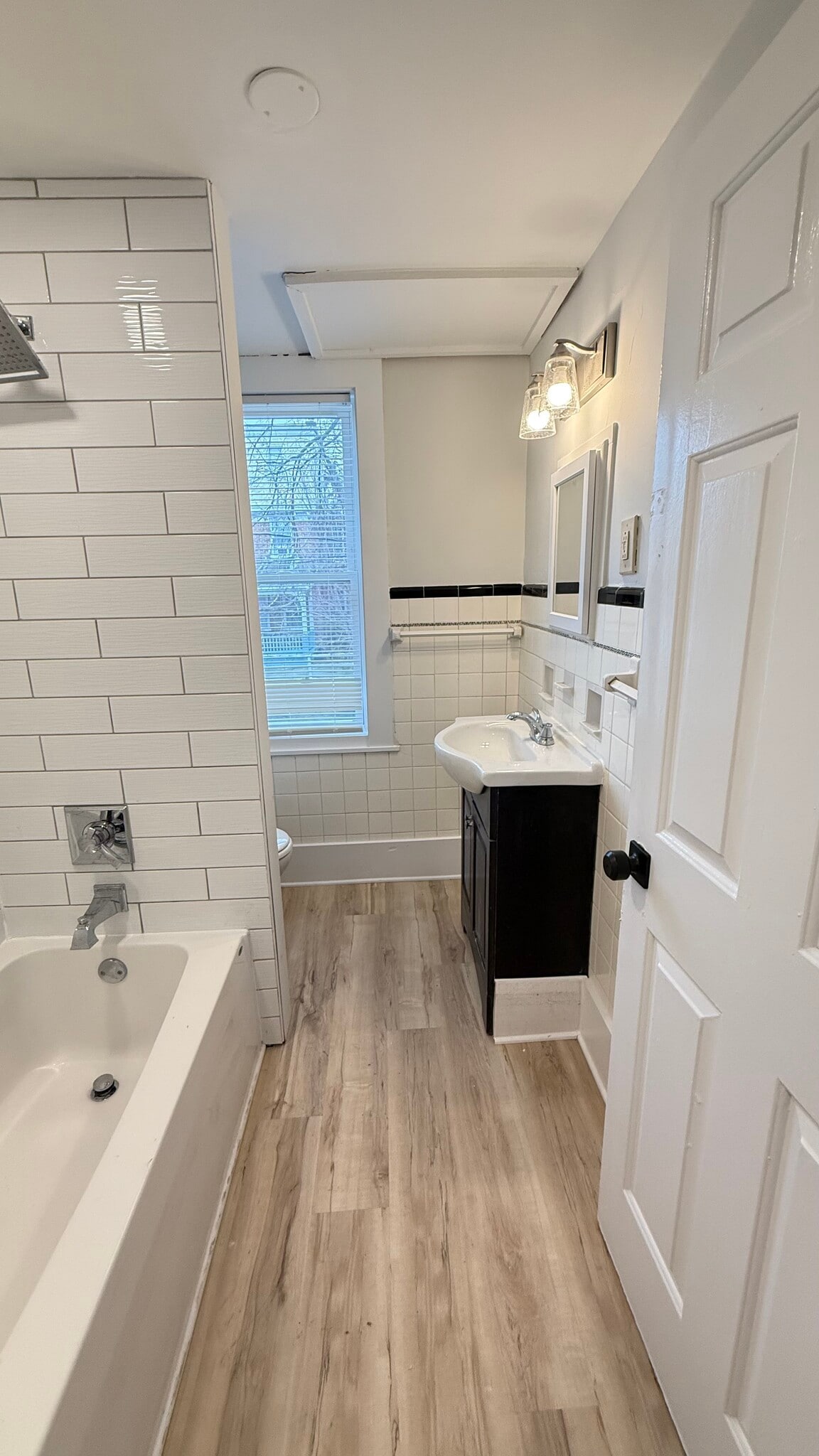 Newly renovated bathroom with tile tub surround and walls - 1024 W 8th St