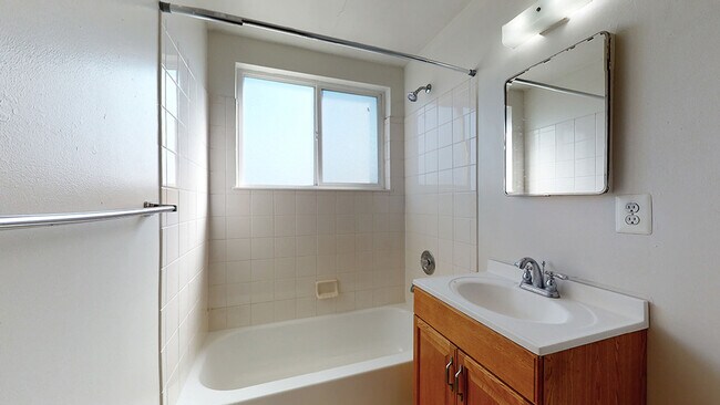 Experience relaxation in this bright and airy modern bathroom. - Harmony Apartments