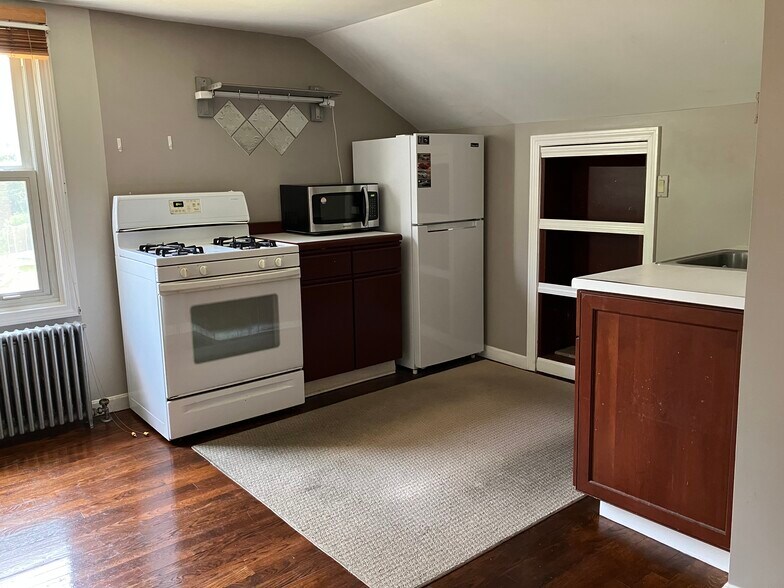 Kitchen includes stove, microwave, fridge with freezer and pantry with additional storage space - 126 Clover Hill St