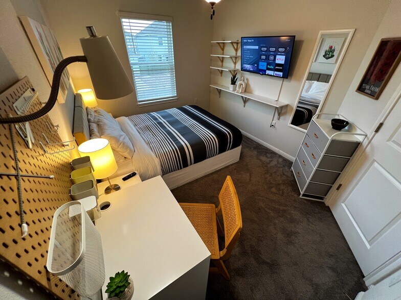 Guest bedroom #1 - Queen storage bed, smart tv, and desk space. - 9611 Morning Iris Dr