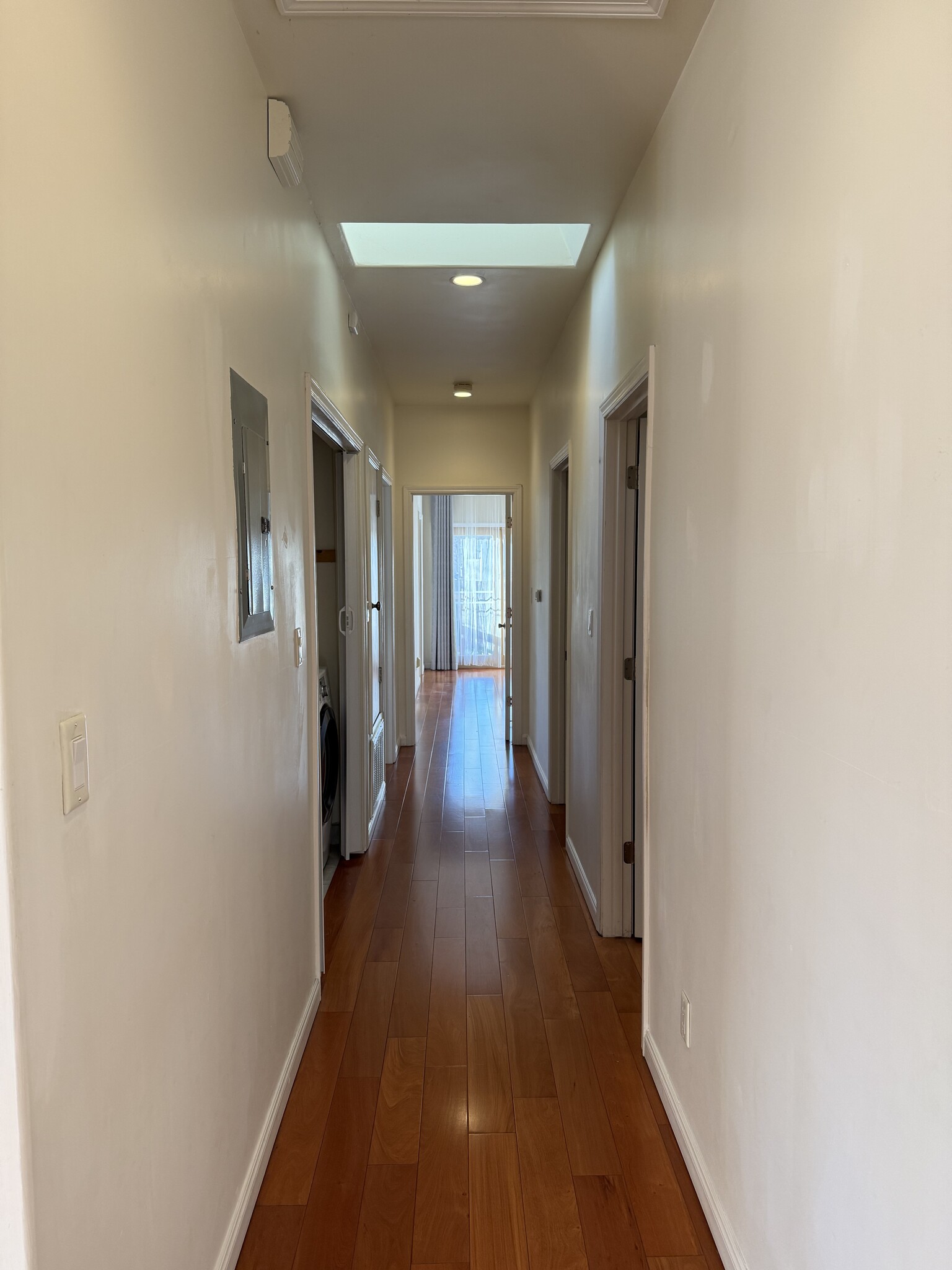 Primary hallway to bedrooms with skylight - 470 Pepper Ave