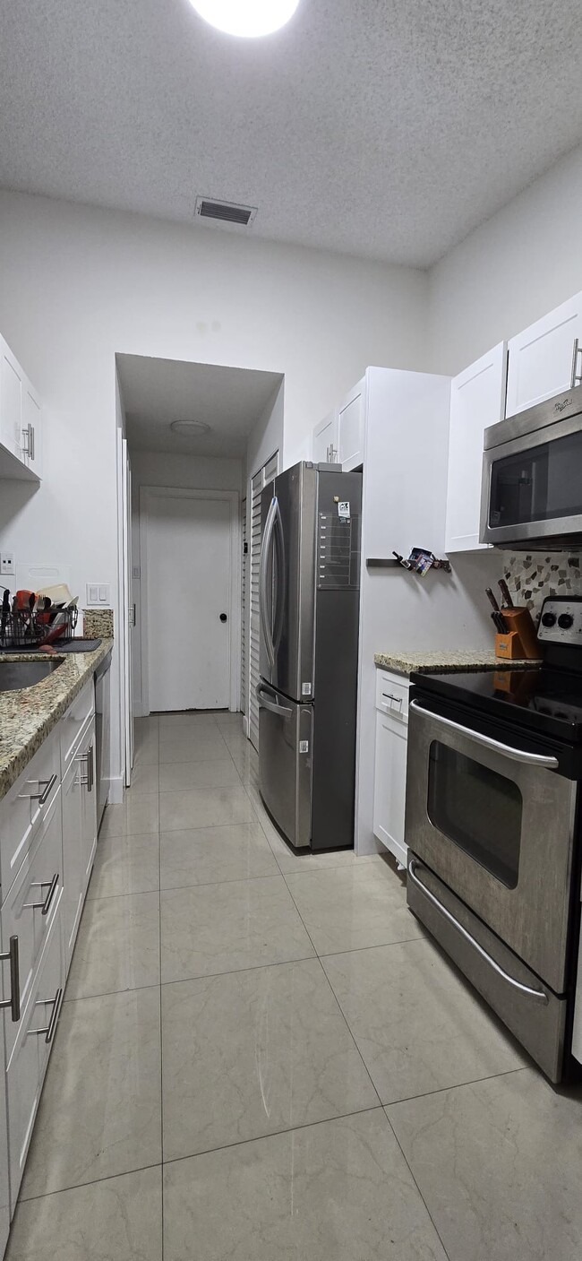 Kitchen with new appliances and granite counter top - 10650 SW 157th Ct