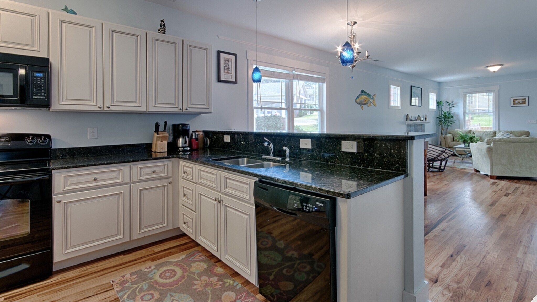 Kitchen with granite counters, breakfast bar, dishwasher, and pendant lighting - 144 Estelle Park Dr