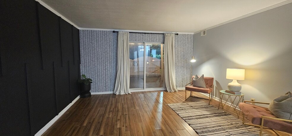 Accent wall featuring a glass sliding door with access to a private patio - 408 La Fontenay Ct
