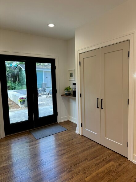 Black french doors open up to the fenced in backyard - 507 Pace St