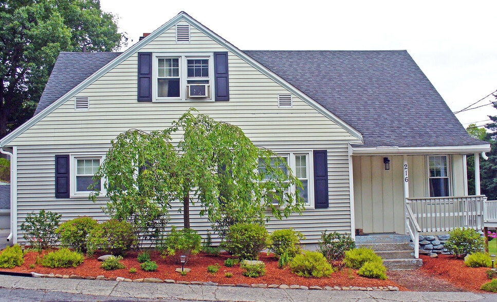 Street view of house with 3 season landscaping - 216 5th St