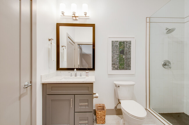 Bathroom with tile flooring and quartz countertops. - 2407 8th Ave S