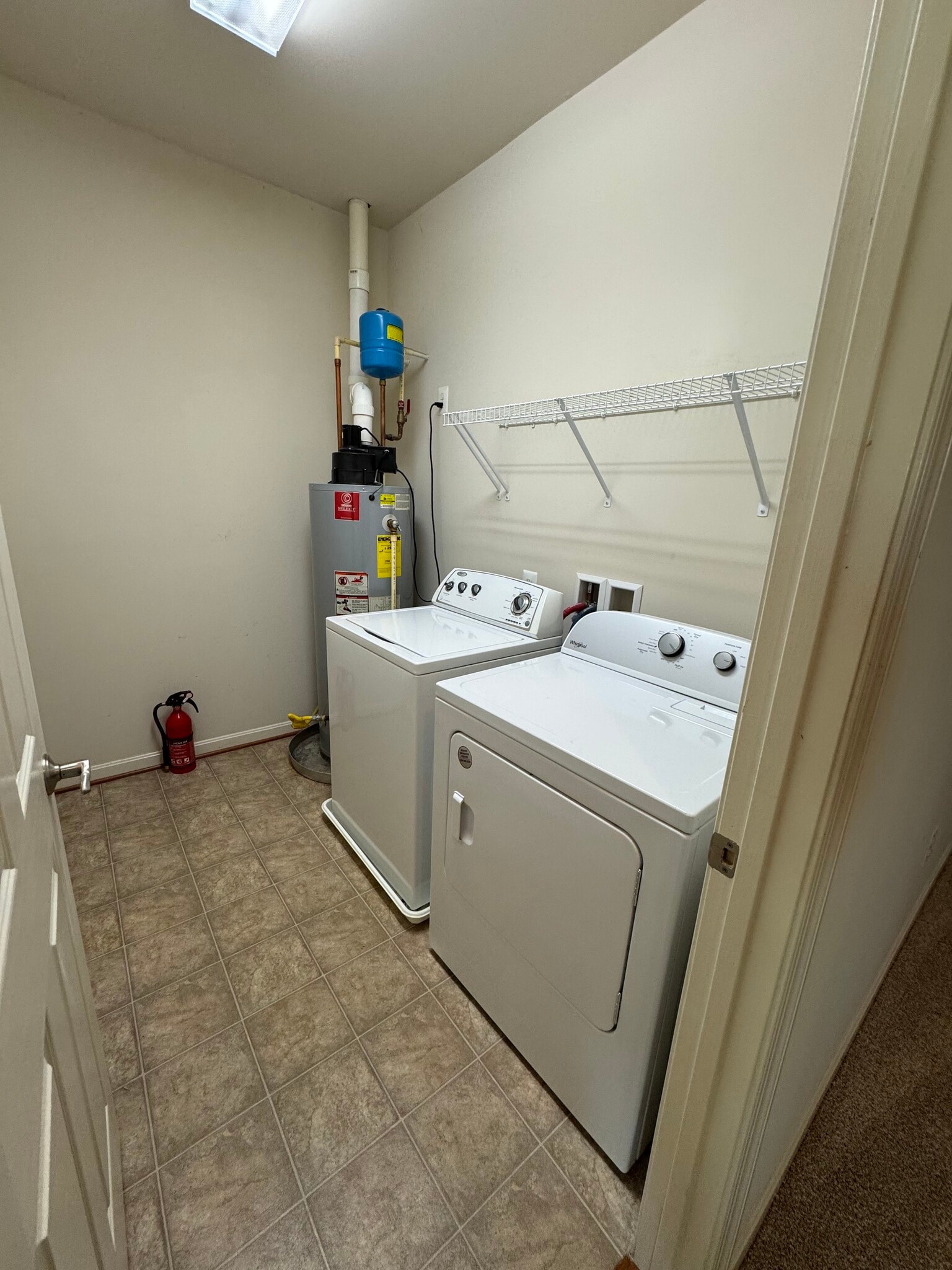 The spacious laundry room includes a Whirlpool washer and dryer. - 44520 Gray Wolf St