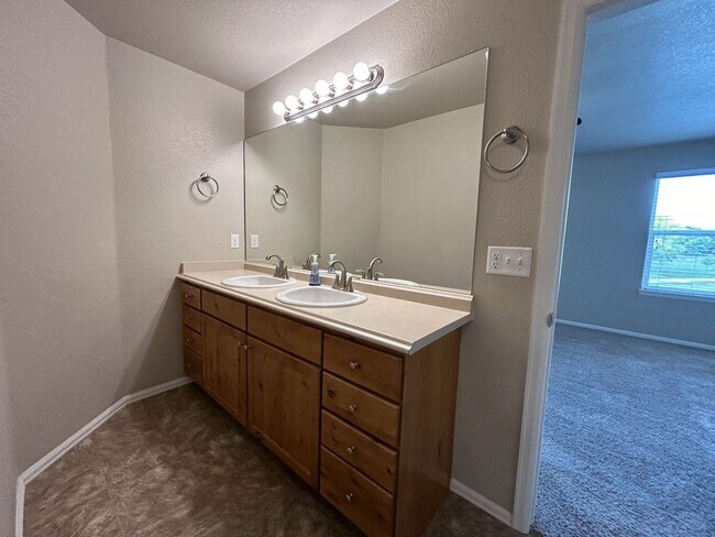 Building Photo - $500 Off First Month Of Rent! Modern 3BR Townhome with Fenced Yard & Garage