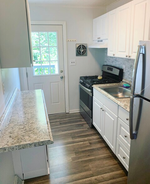 Brand new galley kitchen with stainless steel appliances from dining room - 99 ATLANTIC AVE