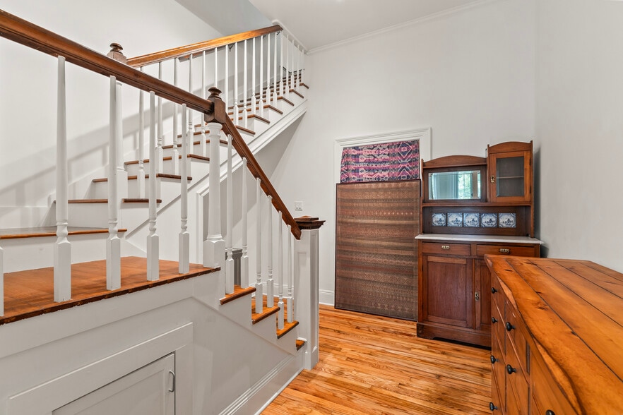 Stairs to second floor with storage, laundry and utility space - 305 E 14th Ave