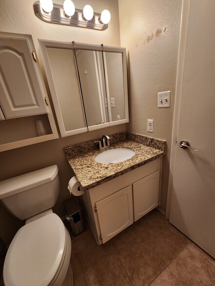 Bathrooms have tiled floors, granite counters and deep sinks. - 5050 N 81st St