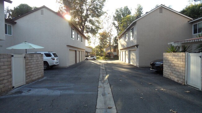 Building Photo - REMODELED 2BR; 1BA end unit condo w/ 1 car garage & 1 parking space