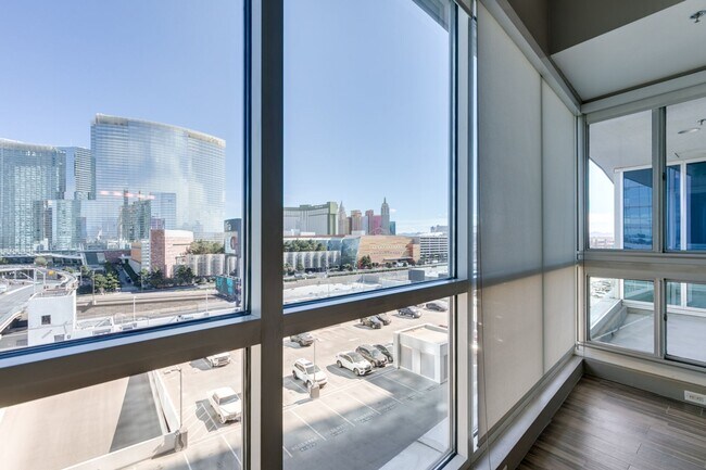 Building Photo - Iconic Strip-View Luxury | Elegant 1BR + Den High-Rise Residence