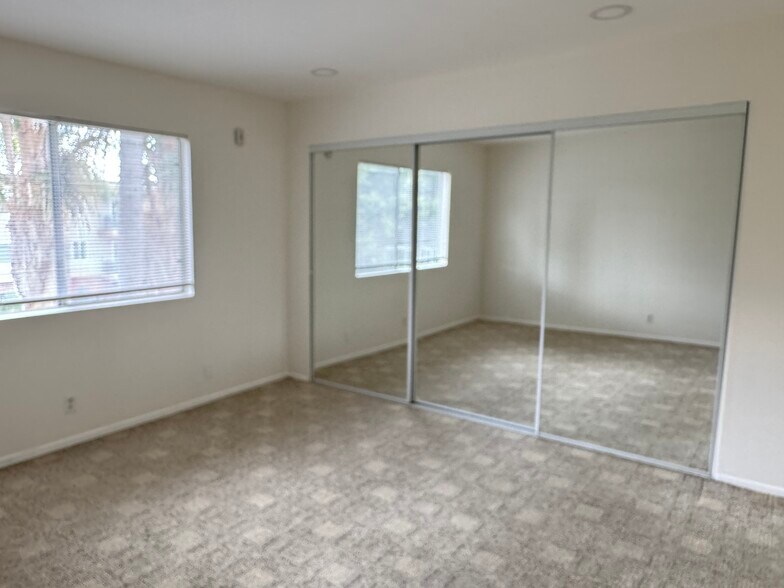 Bedroom with three door mirrored closet - 400 N Acacia Ave