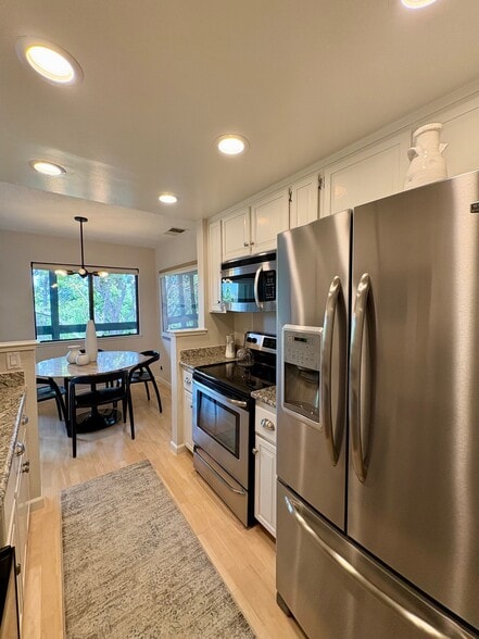 Kitchen with oven, stove, microwave and refrigerator - 820 Sea Spray Ln