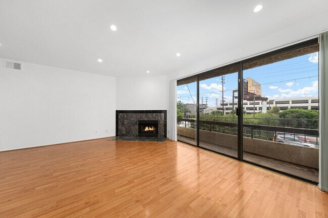 Living room - balcony & fireplace - 1745 S Bentley Ave