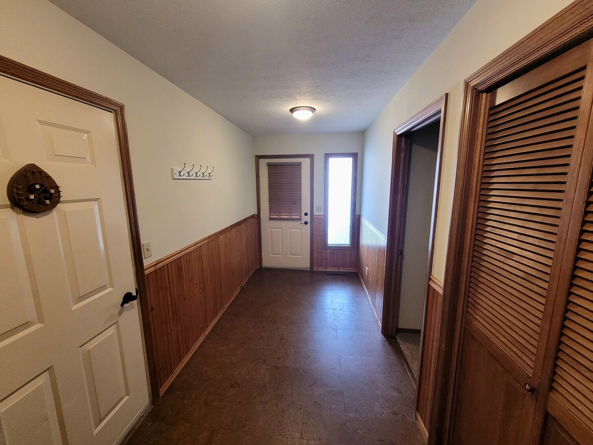 entryway with doors to garage, bedroom, and coat closet - 1711 W Koch St