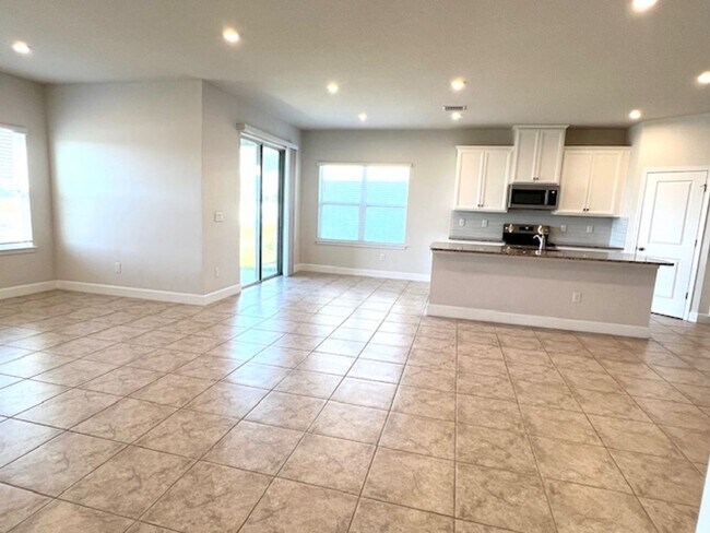 Building Photo - Open concept home offering four bedrooms, three baths, a two car garage and open lanai.