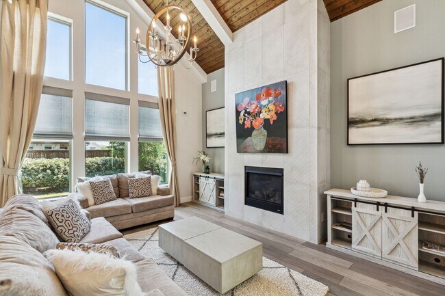 Living room view featuring floor to ceiling custom fireplace and wall of windows - 2871 Cannon Dr